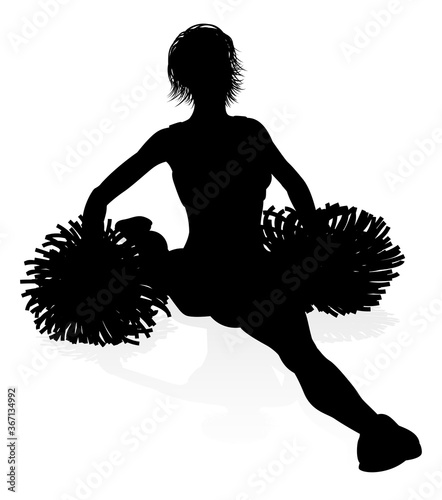 Sports cheerleader in silhouette with pompoms photo