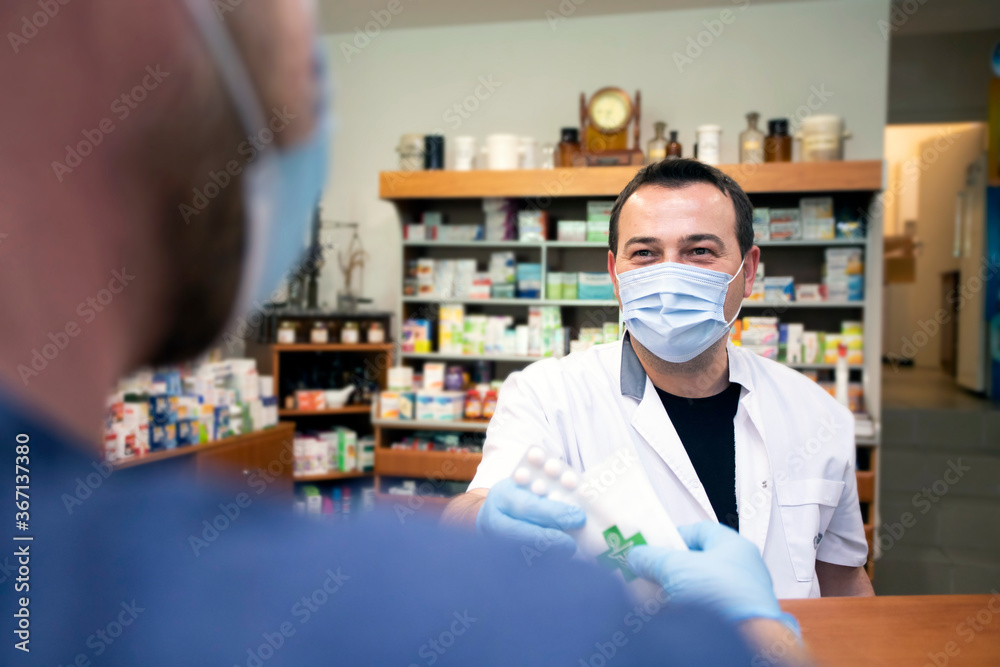 Pharmacist working. Protection in pharmacies. Working in an Alarm State. Protection against coronavirus.