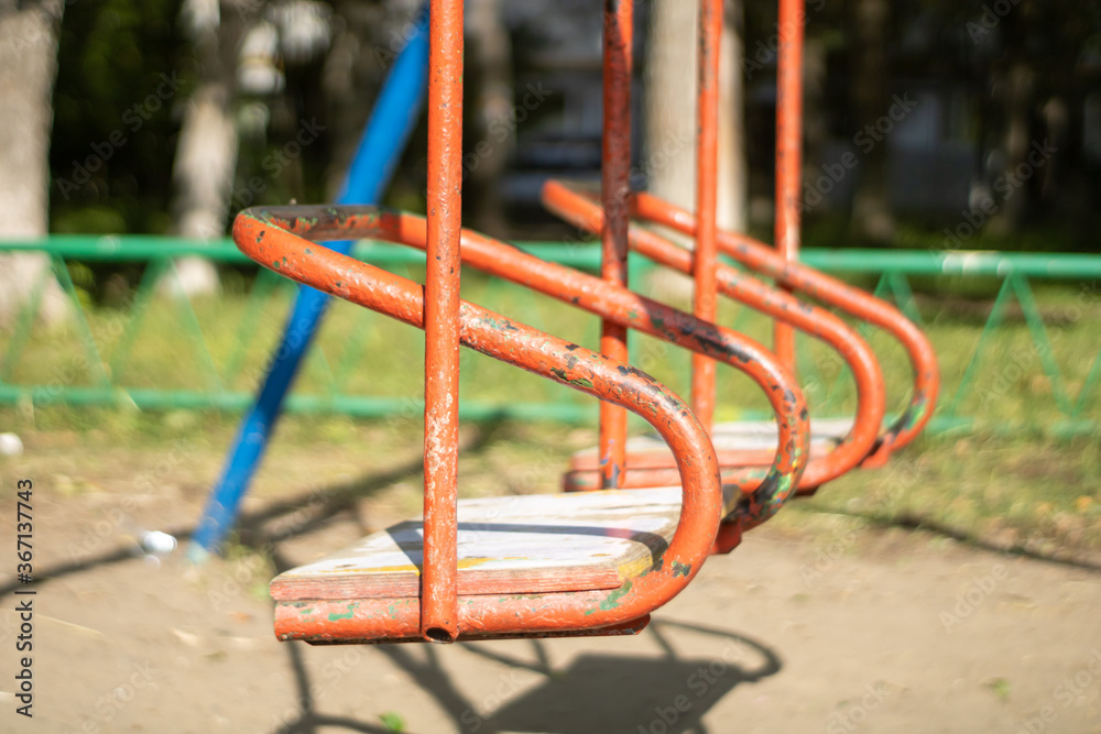 Very old swing for children. Old playground.