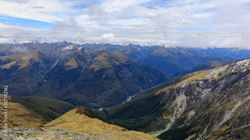 View over the Haast Pass from the summit of Mt Armstrong on the Brewster Track looking out over Mount Aspiring National Park, South Island, New Zealand.