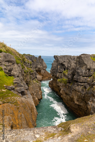 View out to sea over a blowhole at Pancake Rocks on Dolomite Point, South Island, New Zealand.