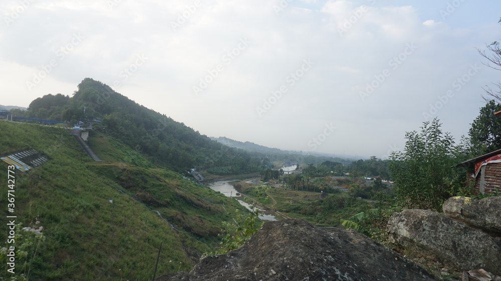 Fototapeta premium The atmosphere in the hills during the morning that looks very beautiful and looks green trees. View and Travel photos