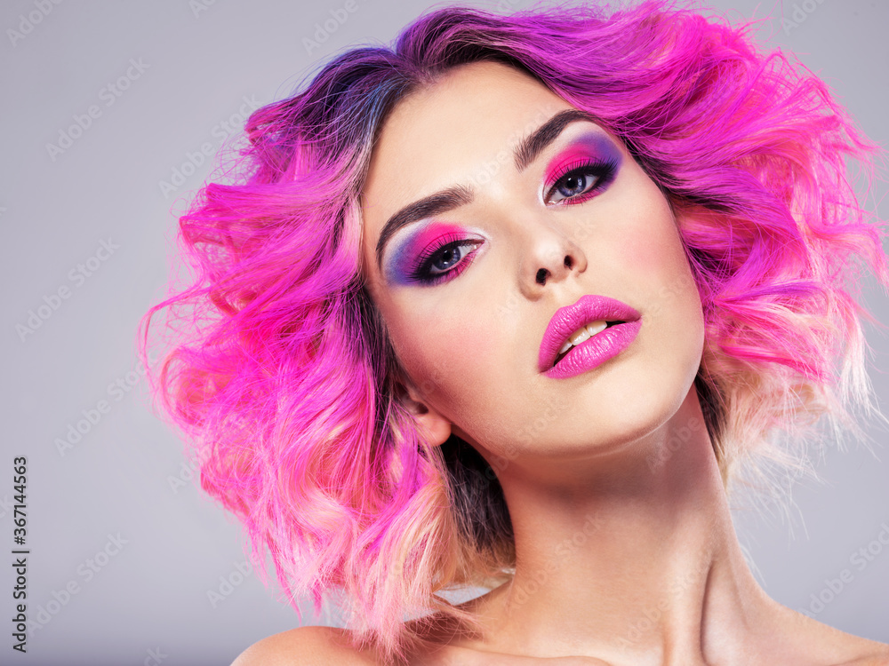 Portrait of beautiful young woman with bright pink makeup. Beautiful blonde with bright pink lipstick on her lips. Pretty girl with vivid hair. Blonde with brightly colored hair. Bright eye makeup. Portrait of beautiful young woman with bright pink makeup. Beautiful blonde with bright pink lipstick on her lips. Pretty girl with vivid hair. Blonde with brightly colored hair. Bright eye makeup.