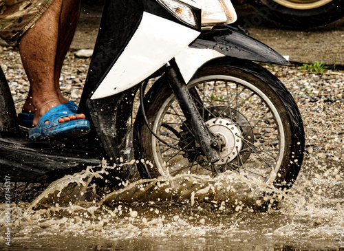 Fototapeta Naklejka Na Ścianę i Meble -  motion motorcycle  rain big dirty puddle of water spray from the wheels