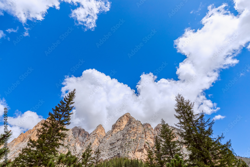 Bottom up view of the Italian Dolomites against the of clear blue sky