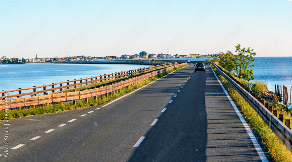 Causeway from the mainland through the lagoon to the island of  Grado, Italy