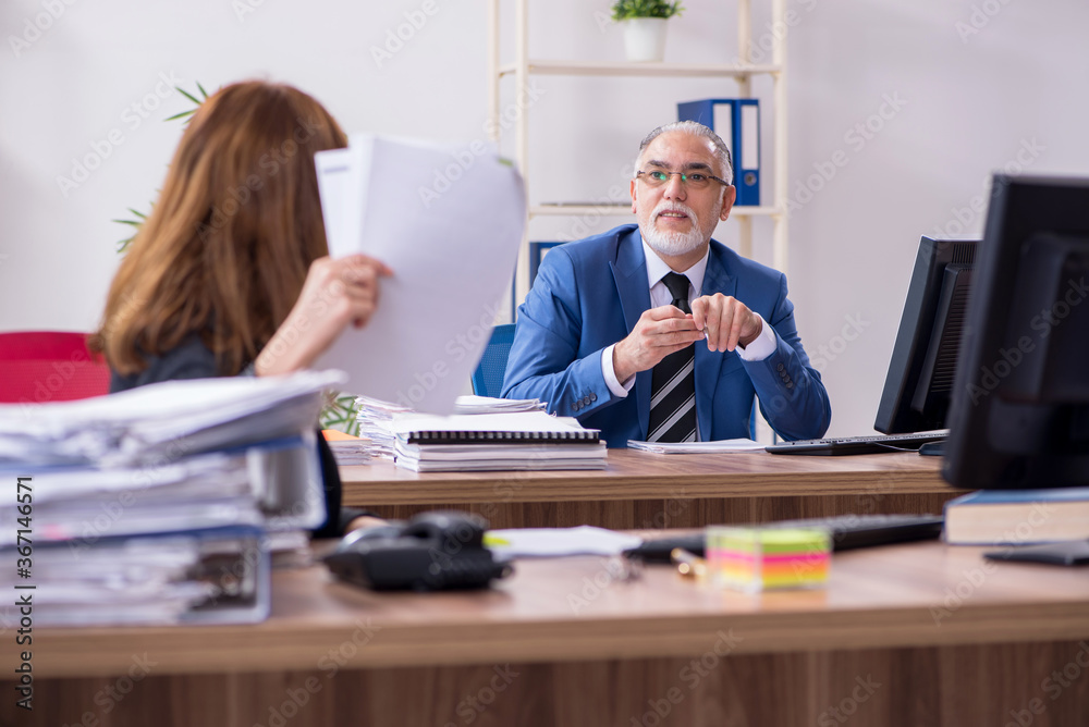 Two employees working in the office Two employees working in the office