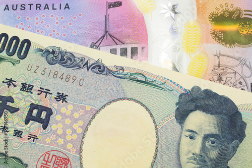 A macro image of a Japanese thousand yen note paired up with a colorful five dollar bill from Australia. Shot close up in macro.