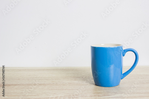 blue cup on wood table