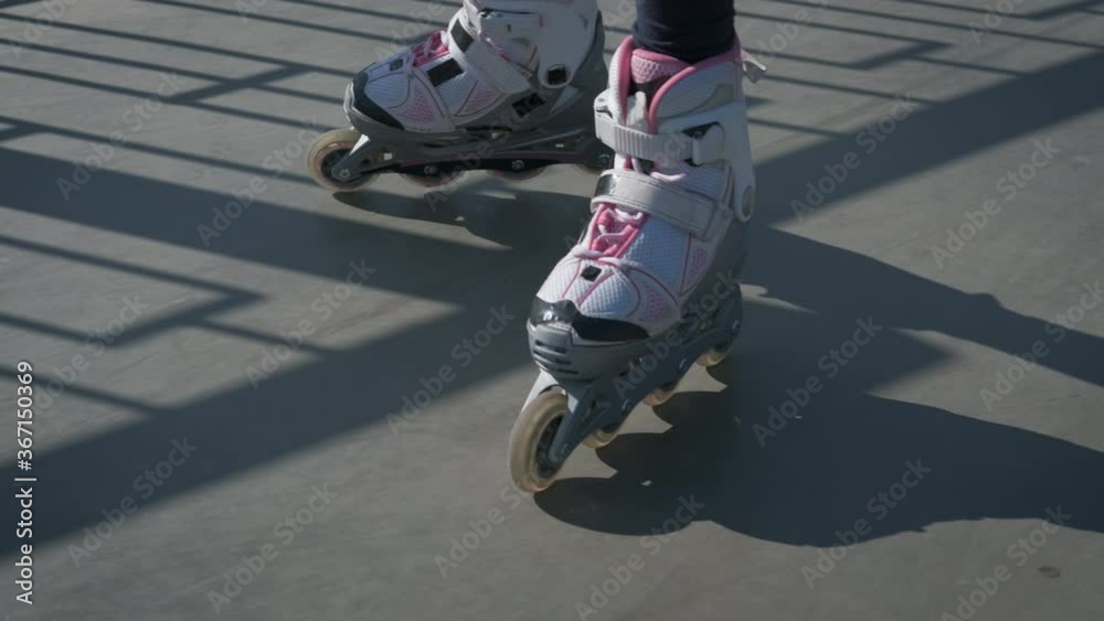 Rollerblading on speed. Legs of a teenager eating on roller skates.