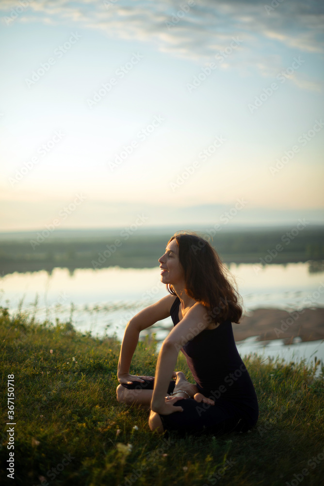 Yoga practice and meditation in nature in sunrise. Woman practicing near big river Kama. Yoga practice and meditation in nature in sunrise. Woman practicing near big river Kama.