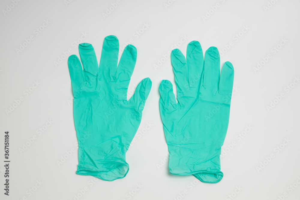 Obraz premium green rubber glove isolated on white background
