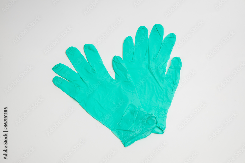 Fototapeta premium green rubber glove isolated on white background