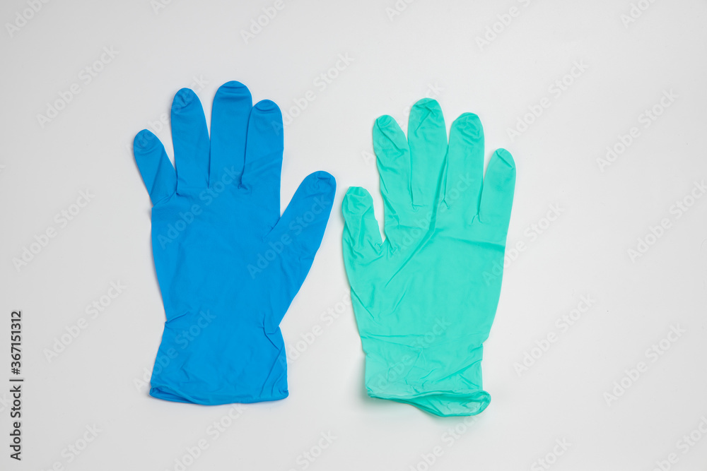 Blue rubber and green rubber glove isolated on white background Blue rubber and green rubber glove isolated on white background