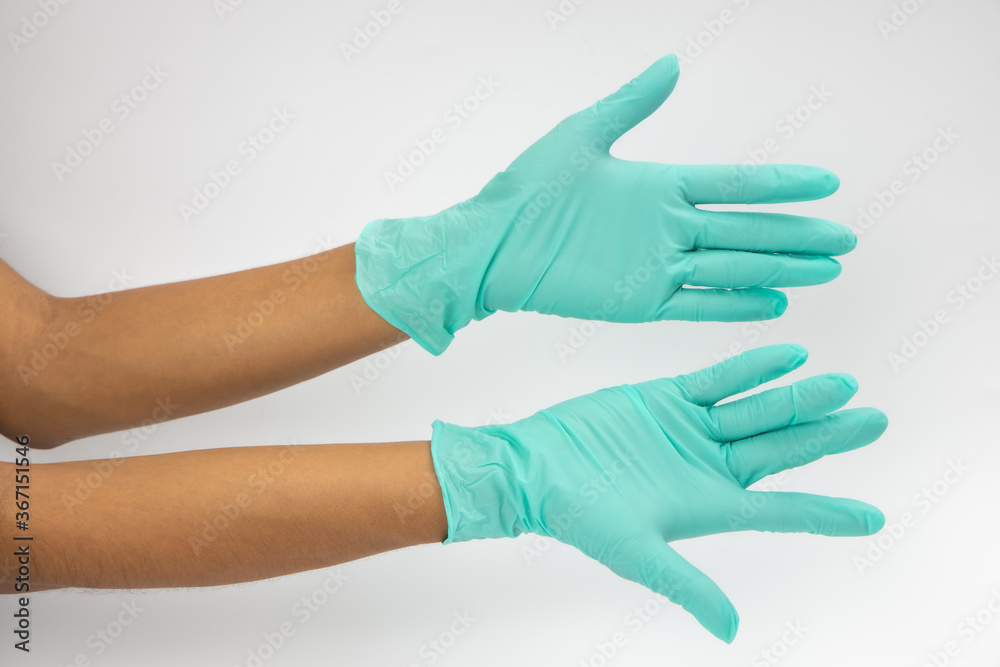 Hand of surgeon in blue medical glove showing Ok sign, isolated on a white background