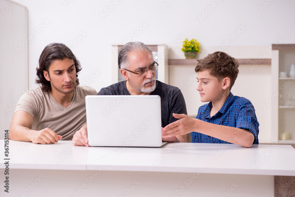 Grandfather learning new technology from son and grandson Grandfather learning new technology from son and grandson