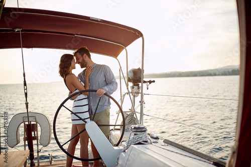 Young couple in love on a yacht