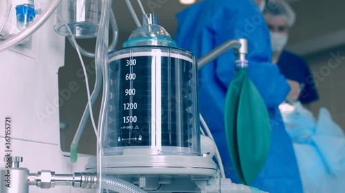 Close-up of a ventilator during an operation, 4k shot. The movement is remembered by artificial lung ventilation, amid a ward with a patient and doctors. Pneumonia and tuberculosis, Covid 19