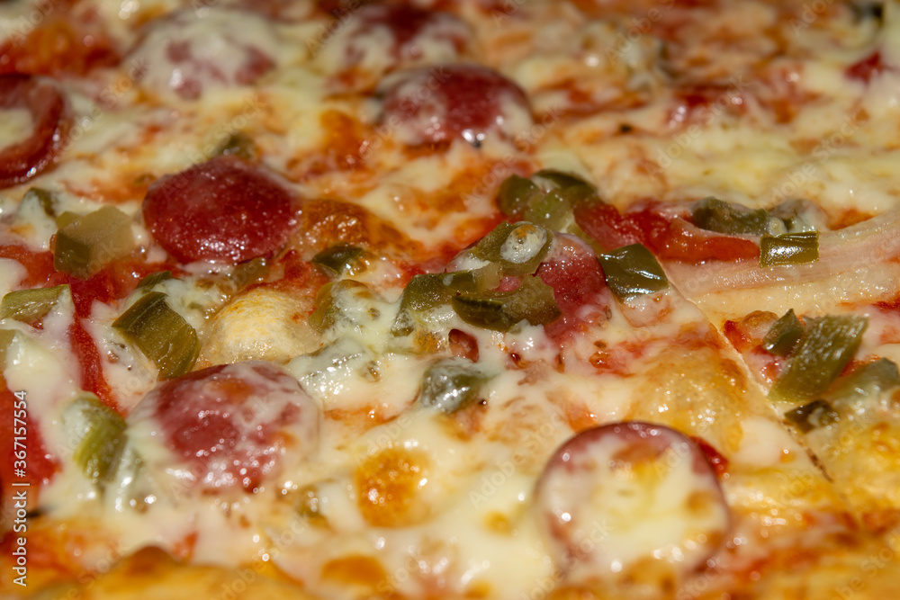 Homemade pizza with sausage, mushrooms and mozzarella cheese. Close up.