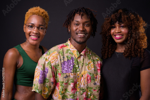 Foto Group of African friends together against black background