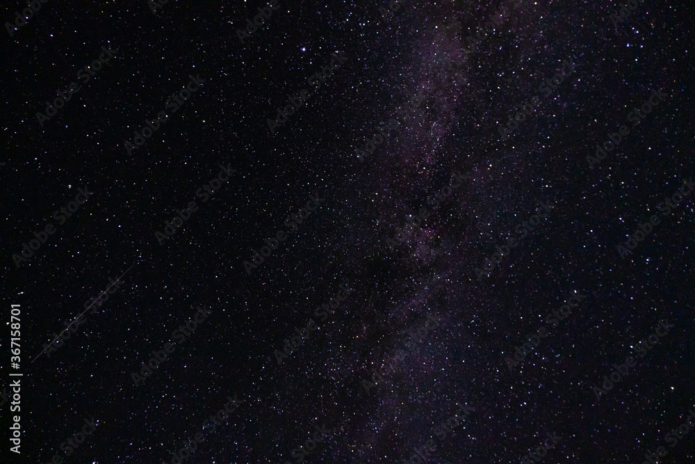 Fototapeta premium View of the milky way from the Northern hemisphere of the planet Earth. Beautiful bright night starry sky. Many different constellations in the black night sky. Galaxy with cosmic bodies.