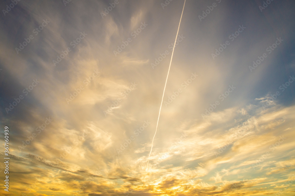 Sunset Sky with Airplane Trail in the Clouds Sunset Sky with Airplane Trail in the Clouds