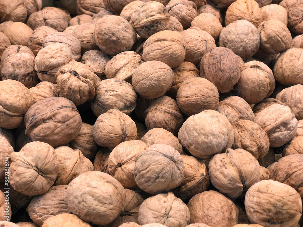 walnut in a shell, close-up, on the counter of the store. Proper nutrition, snacking. The nuts are close-up. Food for the mind, healthy food