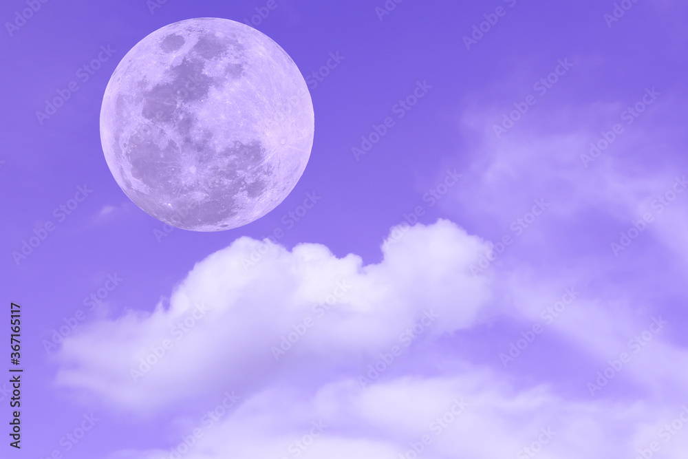 Full moon with blurred clouds on purple sky.