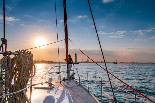 A girl meets an autumn sunset on a yacht in the Black Sea