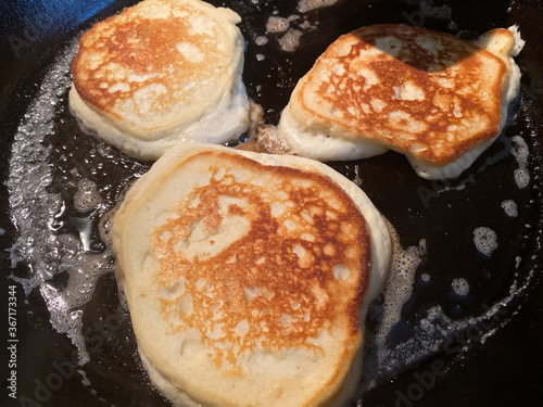 Pancakes Cooking in Cast Iron Skillet