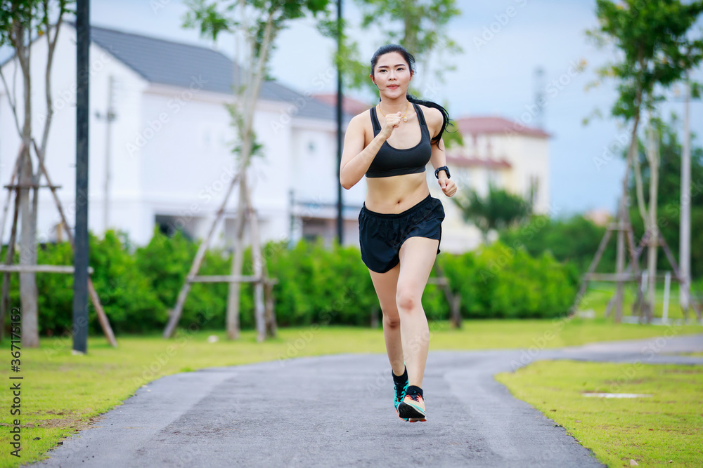 asian woman running in village park