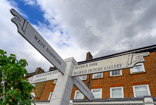 Photography A local sign with pointing hands in Dulwich Village, Greater London, UK
