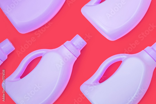 Purple bottles with chemicals for cleaning on a red background. Seamless pattern. Cleaning concept