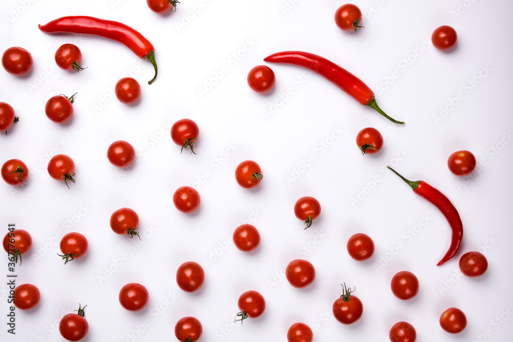 Red chili peppers and tomatoes isolated on white background. Red chili peppers and tomatoes isolated on white background.