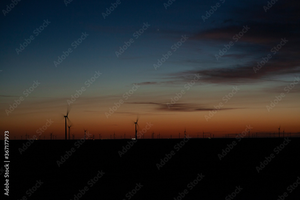 Fototapeta premium Wind turbines on a farm at dawn