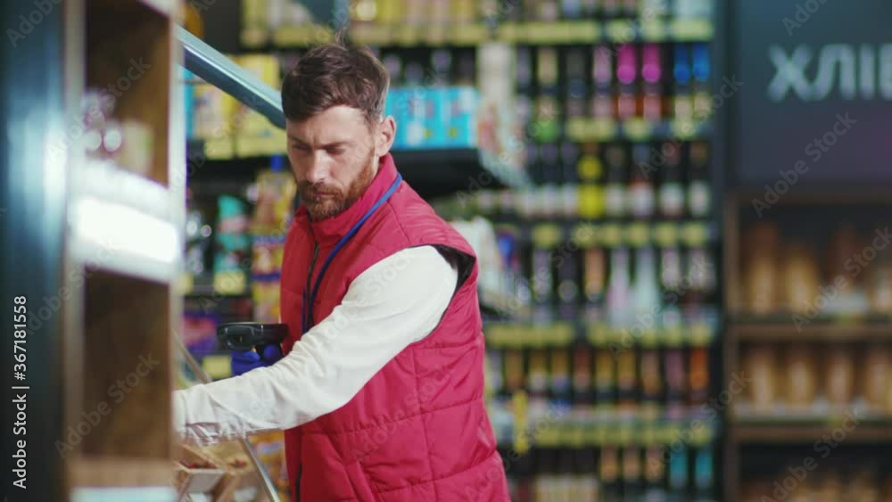 Close up young seller man puts vegetables on the shelf in supermarket check vegetable business beautiful fresh produce retail shop slow motion