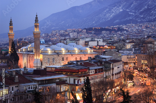 Historical Grand Mosque (Ulucami), Uludag with snow and Bursa city night landscape.