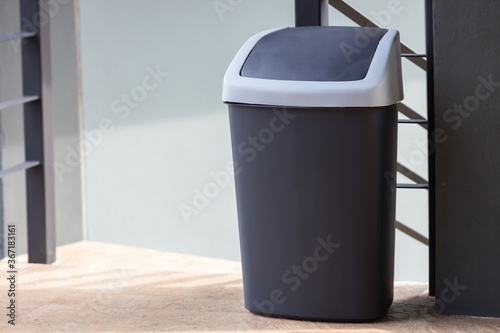 A black bin at home. black trash can. Garbage trash bin.