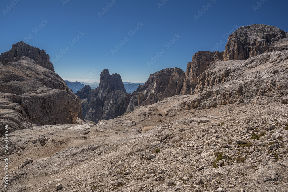 Fototapeta premium Pale di San Martino mountain group summits from L to R, Cima Canali, Cimerlo, Sass Maor, Cima della Madonna, as seen from Pradidali Basso pass, at the foot of Fradusta glacier, Dolomites, Italy.
