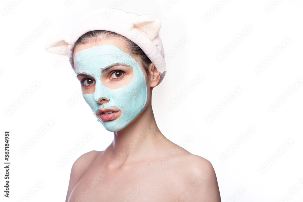 woman in a cosmetic mask on her face  in a funny headband