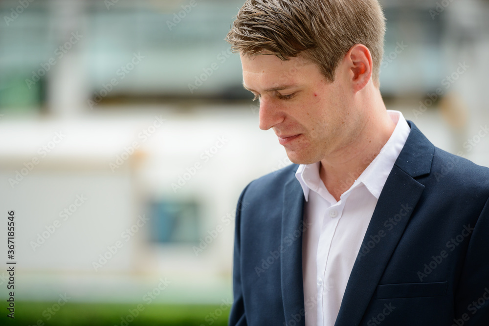 Young handsome businessman in the city streets outdoors Young handsome businessman in the city streets outdoors