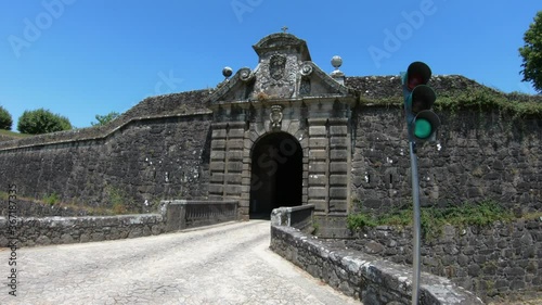 DOLLY SHOT SLOW MOTION - The Porta da Coroada (Crown) is located on the south of Fortaleza, preceded by a stonework bridge with a guard also made of hollow stonework.  photo