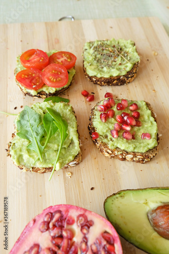 Delicious and healthy guacamole sandwiches on a bamboo board 