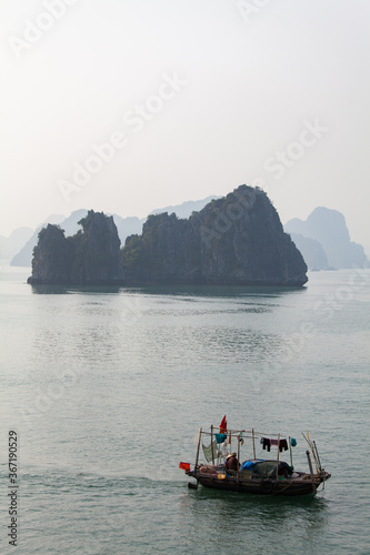 Ha Long Bay, Vietnam, towering limestone islands with traditional fishing boat