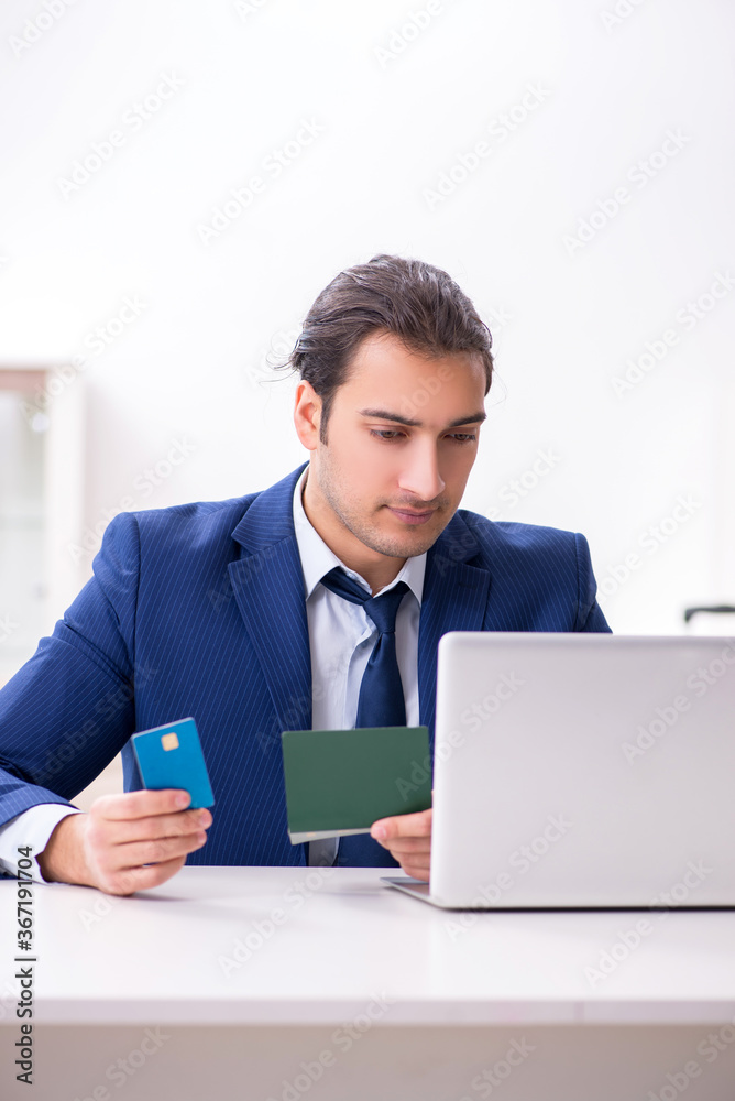 Young businessman holding passport preparing for trip Young businessman holding passport preparing for trip