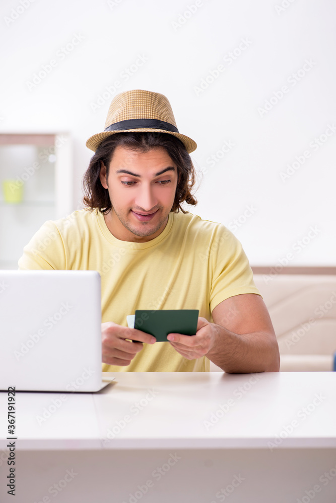 Young man holding passport preparing for summer trip Young man holding passport preparing for summer trip