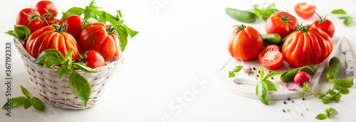 Fototapeta Naklejka Na Ścianę i Meble -  Assorted fresh ripe tomatoes and basil in basket.  Healthy food concept. Clean eating