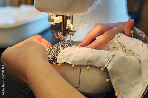 Handmade Medical Face Mask Closeup of Hands Using Sewing Machine During COVID-19 Pandemic