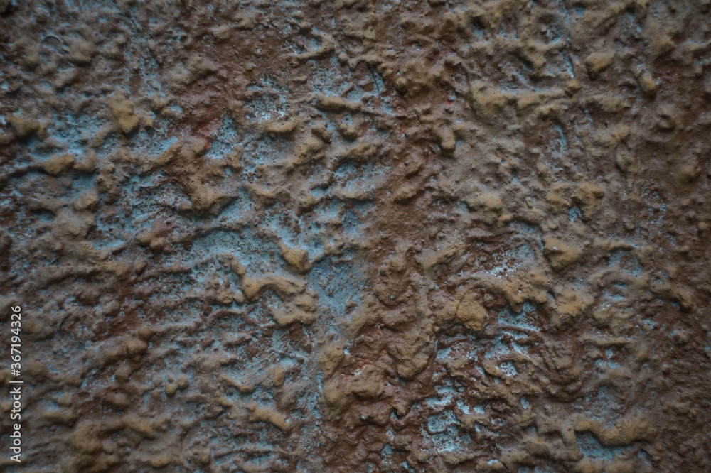 Still-life. Photo of the wall surface with streaks and clumps of plaster. In Dark Reds and bright Blues. Still-life. Photo of the wall surface with streaks and clumps of plaster. In Dark Reds and bright Blues.
