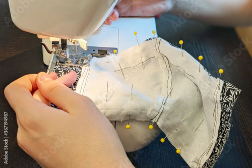 Handmade Medical Face Mask Closeup of Hands Using Sewing Machine During COVID-19 Pandemic